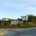Bright, sunny street in a residential Atlanta neighborhood, featuring a mix of beautiful modern and traditional homes, rep...