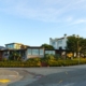 Bright, sunny street in a residential Atlanta neighborhood, featuring a mix of beautiful modern and traditional homes, rep...
