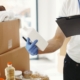 Diverse group of volunteers works together in a brightly lit space, sorting through boxes of food, water, and clothing don...